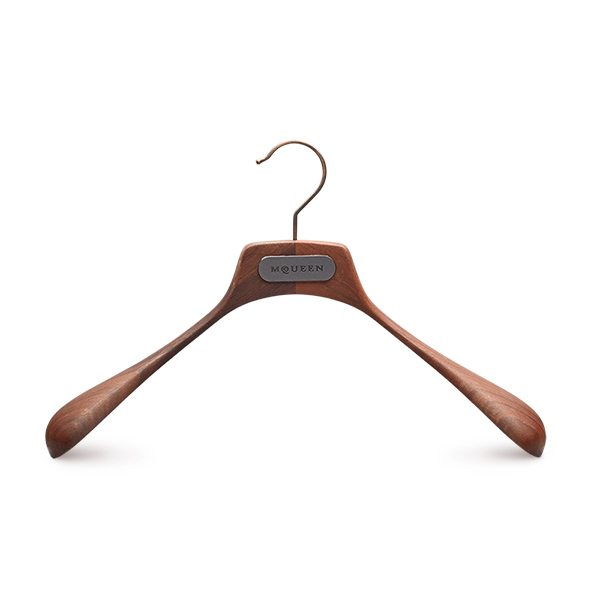 Wooden jacket hanger made from walnut with natural finish, antique metal parts and metal plate logo for Alexander McQueen